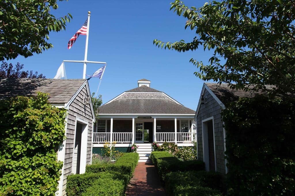Naushop clubhouse straight view with American flag next to it.